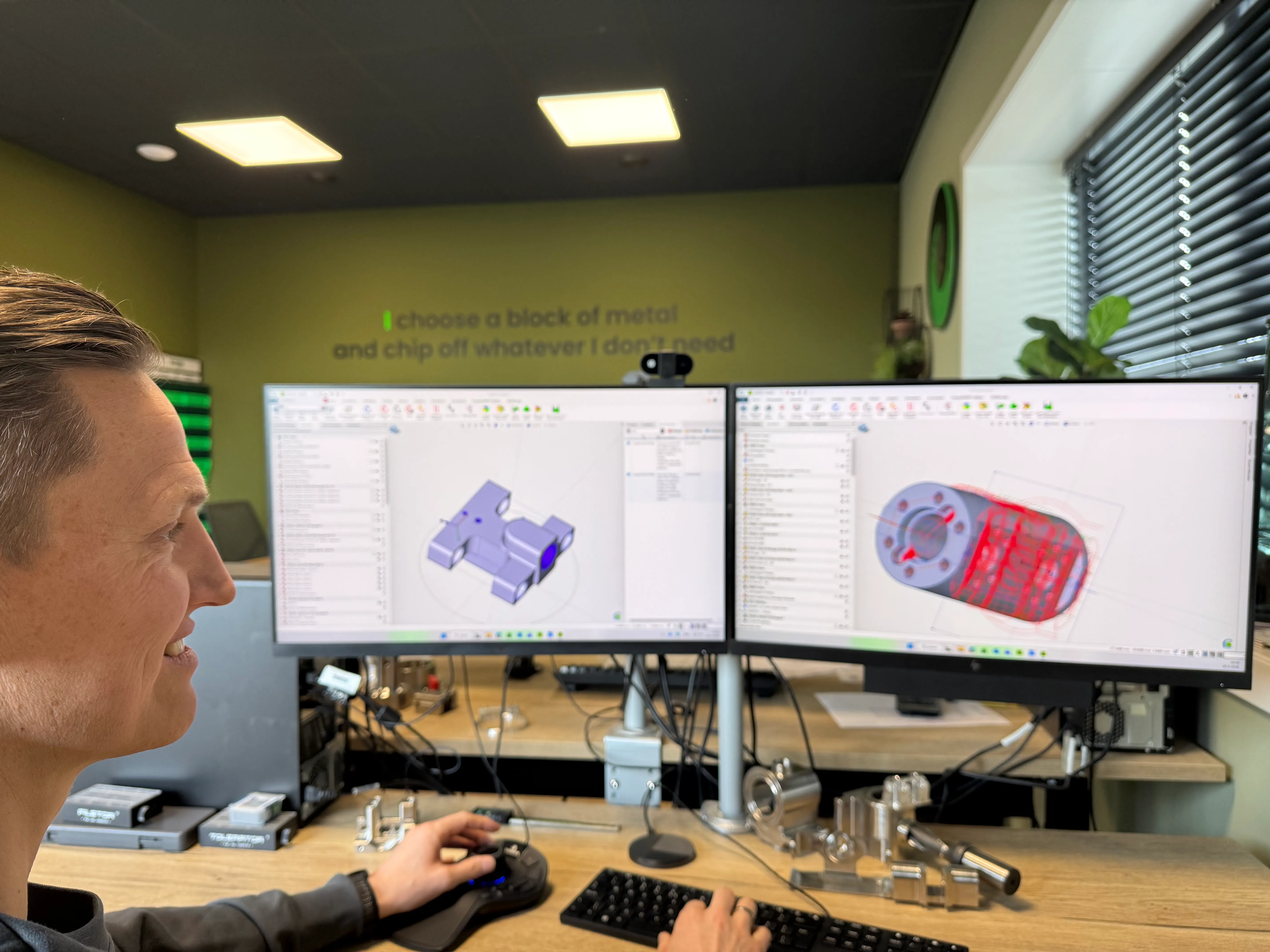 CNC Engineer at work with CAM software on two screens